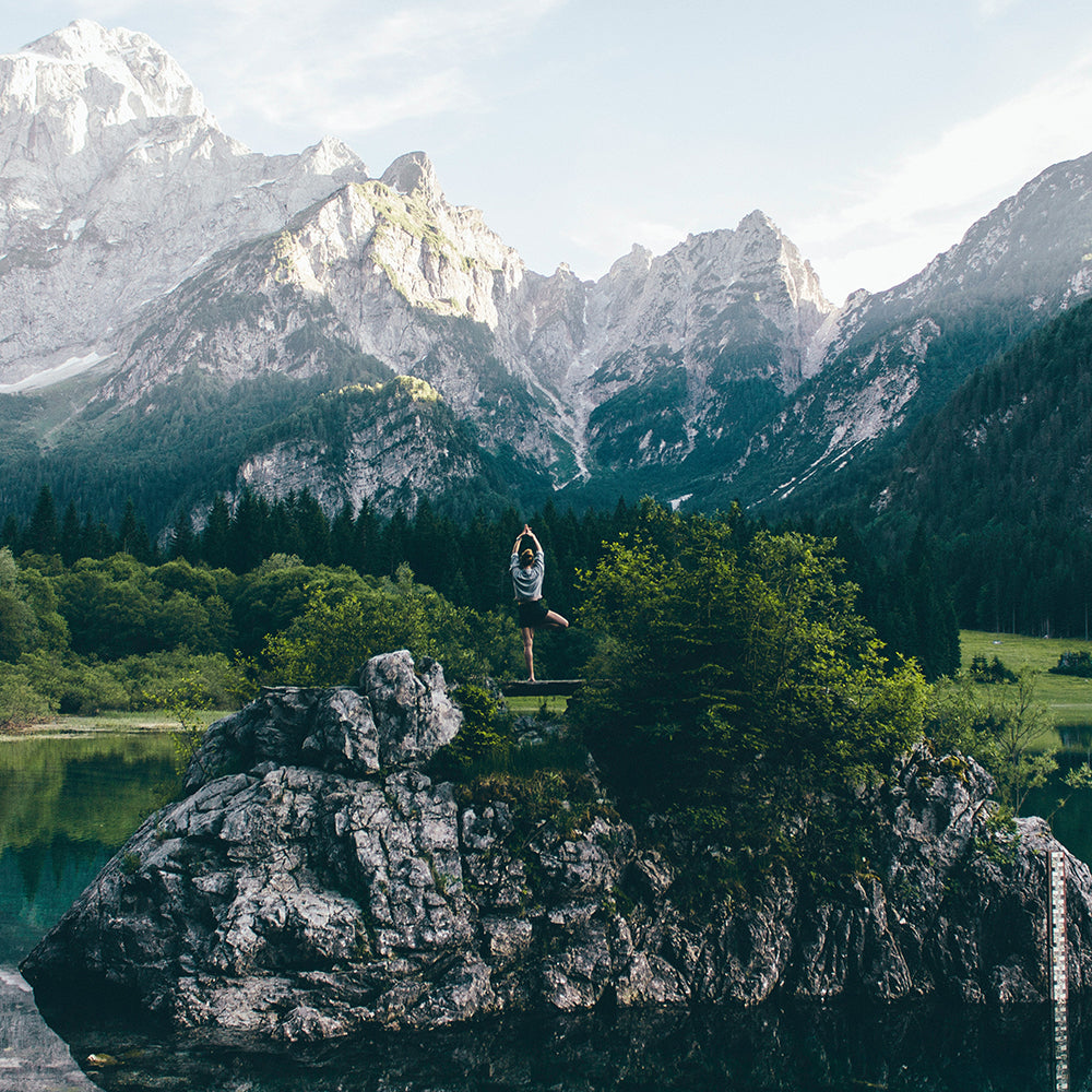 Woman doing yoga in front of mountains