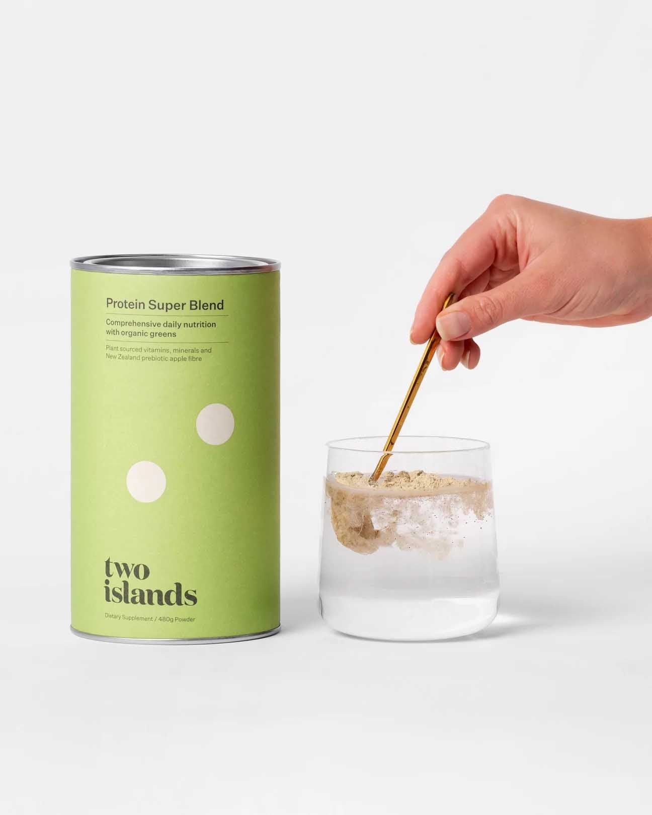 Two Islands Protein Super Blend With powder being stirred into water